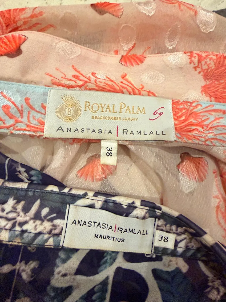 Garment labels reading Royal Palm Beachcomber Luxury by Anastasia Ramlall, and Anastasia Ramlall Mauritius